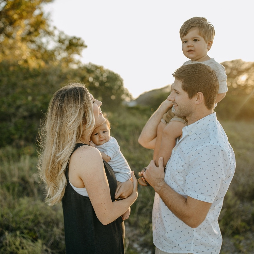 Young couple posing for sunset portraits on the beach in Perdido Key Florida.