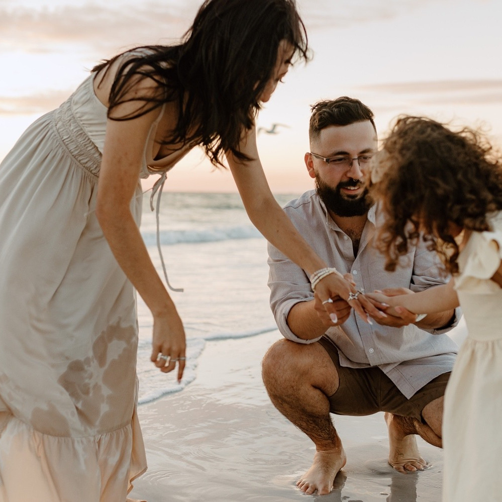 Small family playing at Destin Beach