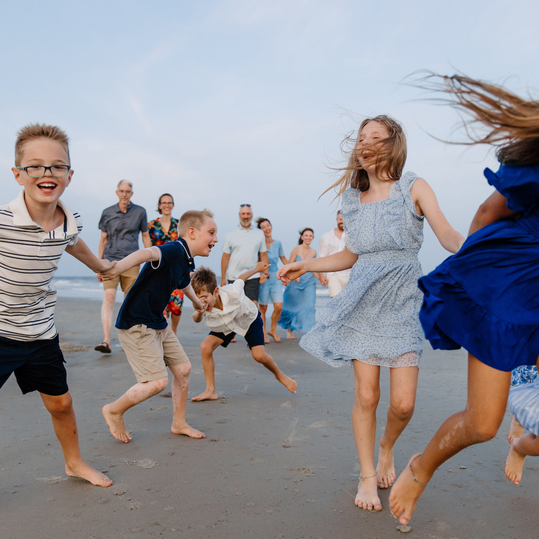 Large family posing for a portrait in Gulf Shores, Alabama by Shore Shooters