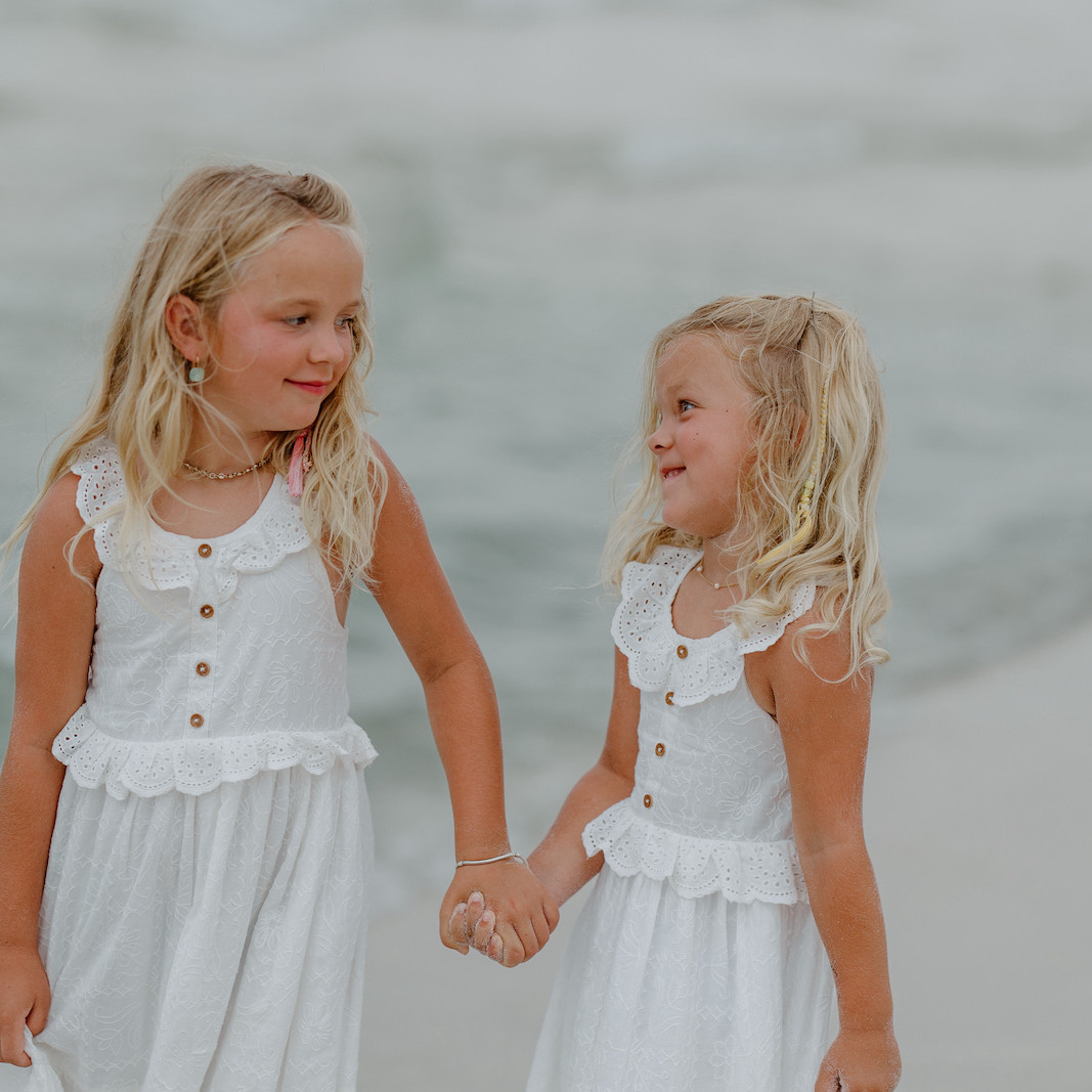 Two sisters posing for a portrait in Gulf Shores, Alabama by Shore Shooters