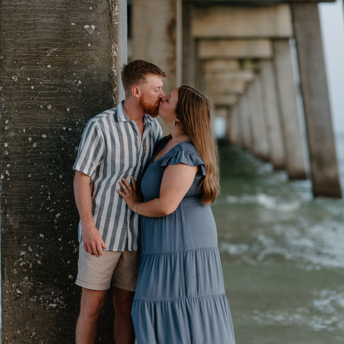 Couple under a wharf in Orange Beach, AL