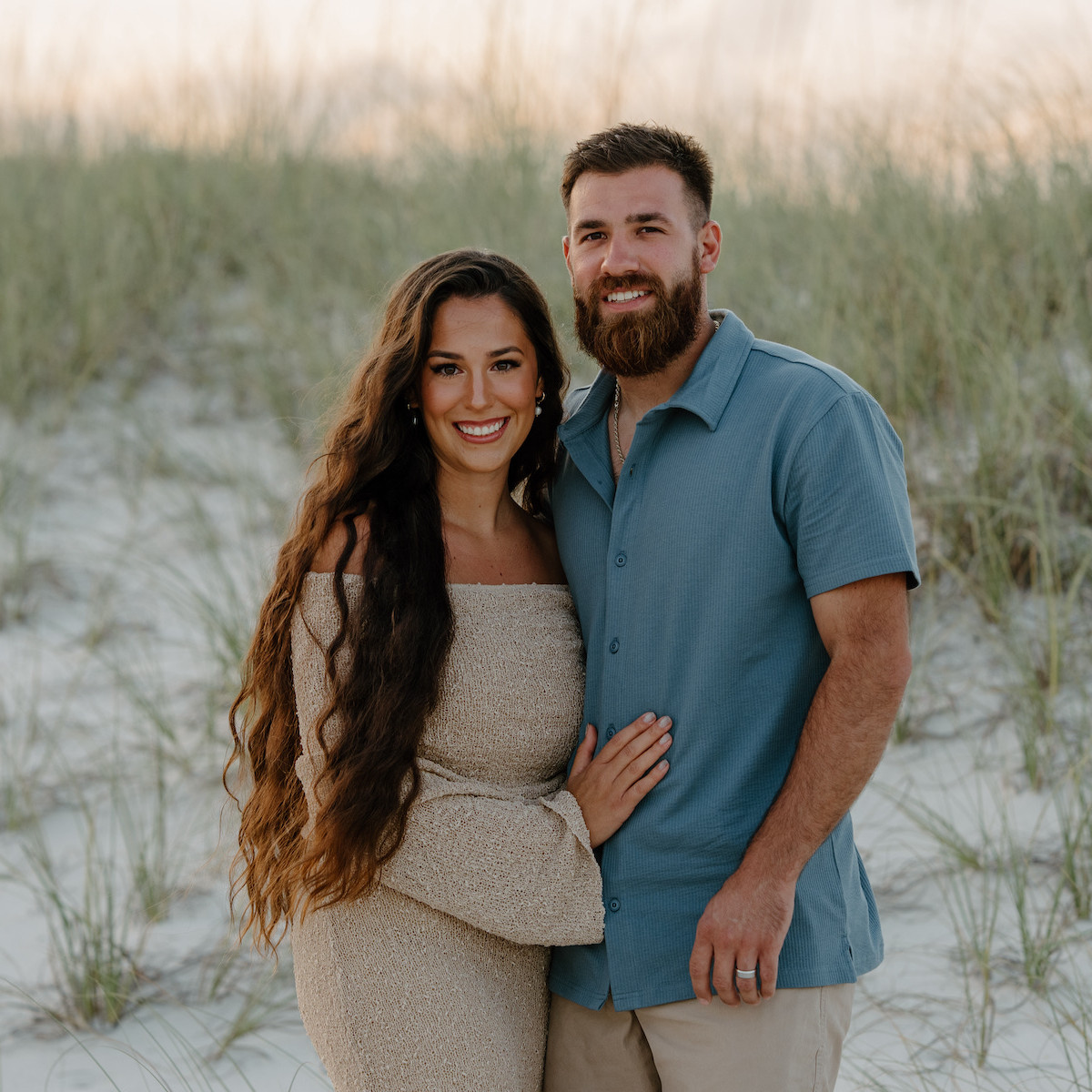 Couple posing in Orange Beach at sunset