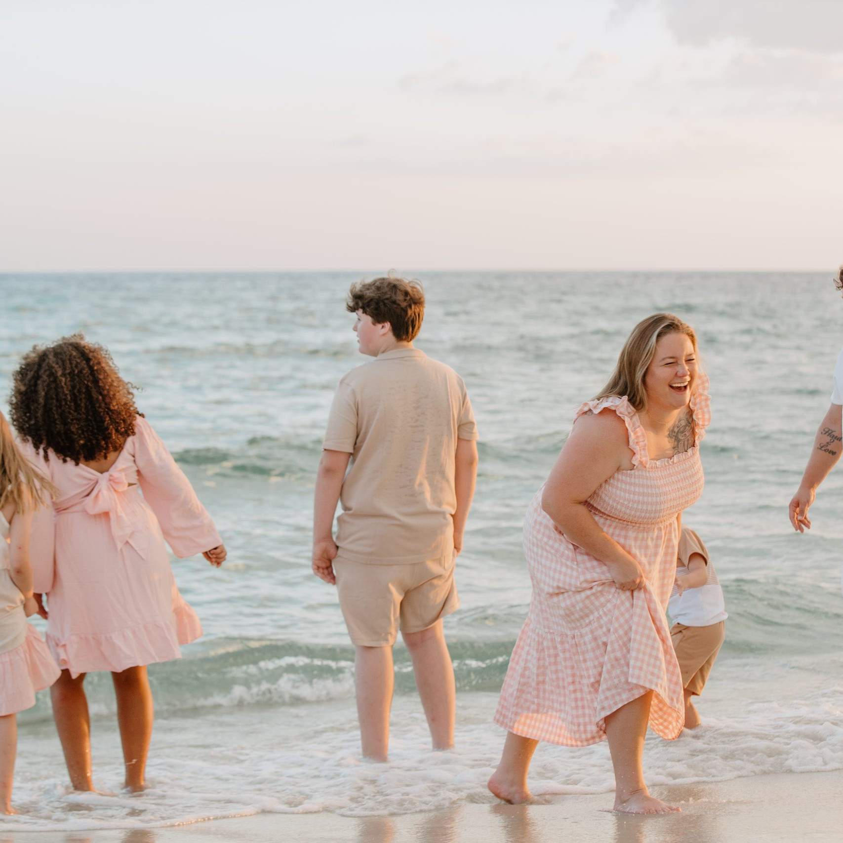 Family posing on the beach in Panama City Beach, Florida by Shore Shooters