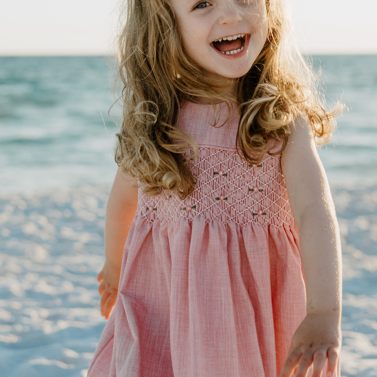 little girl smiling in Panama City Beach by Shore Shooters